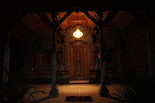 a dark room with a door and a light at Umah Desa in Banjarangkan