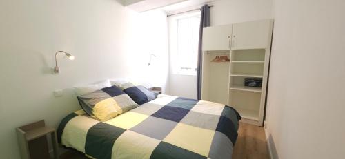 a bedroom with a bed with a blue and white at Le Patio Saint Pierre in Auxerre