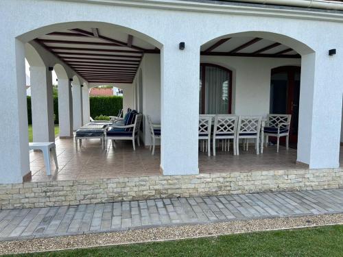 a patio with chairs and tables on a house at Vila Y2 in Arena Regia Residence - Adults only-14 and above- No parties allowed in Mamaia Nord