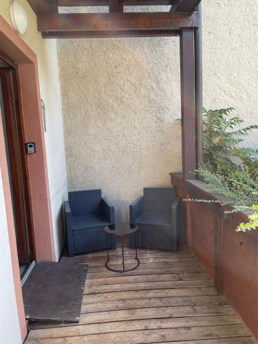 a patio with two blue chairs and a table at City Apartment Bad Säckingen mit Parkplatz in Bad Säckingen