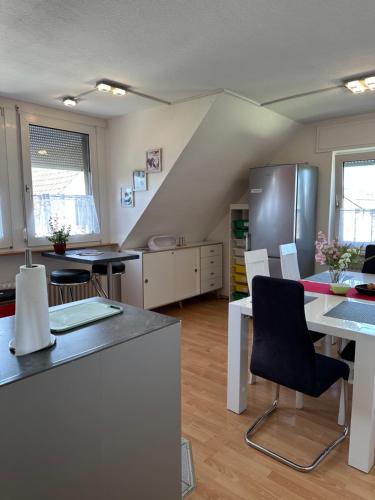 a kitchen with a table and chairs and a refrigerator at Diamanthaus 1 Koblenz in Koblenz