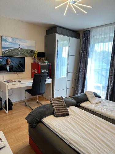 een slaapkamer met een bed en een bureau met een computer bij Diamanthaus 1 Koblenz in Koblenz