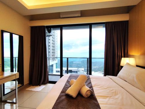 a hotel room with a bed with large windows at TopGenting SkySunColdSuite5Pax at GrdIonDelmn in Genting Highlands