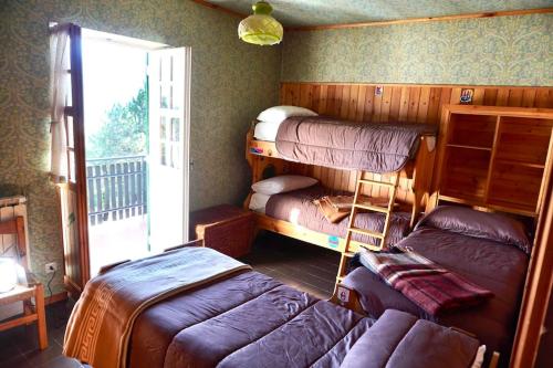 a room with three bunk beds and a couch at Il Rifugio da Aldo - Rivisondoli in Rivisondoli
