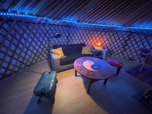 a room with a couch and a table in a room at Les songes du chêne in Augirein