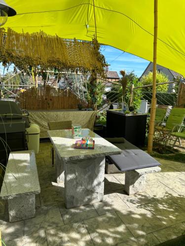 a patio with a table and a yellow umbrella at Diamanthaus 1 Koblenz in Koblenz