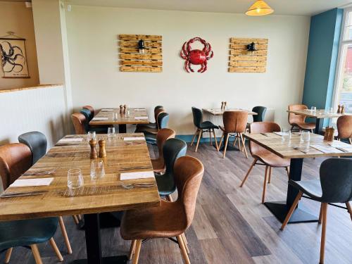 a dining room with wooden tables and chairs at Beach House Hotel in Seahouses