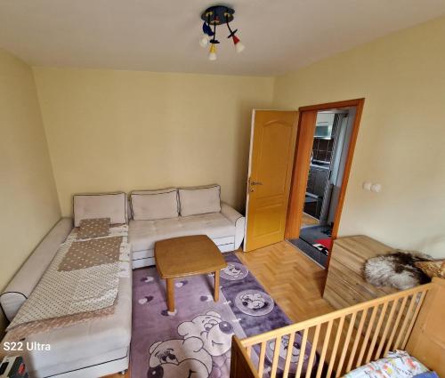 a small room with a couch and a table at Apartman PanoramaTz in Tuzla