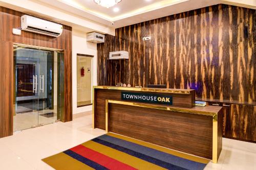 a lobby with a front desk in a building at OYO Palette - The Grand Aryans Hotel in Kolkata