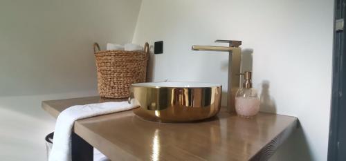 a gold bowl sitting on a counter with a towel at Stone Chalets LUNA in Jajce