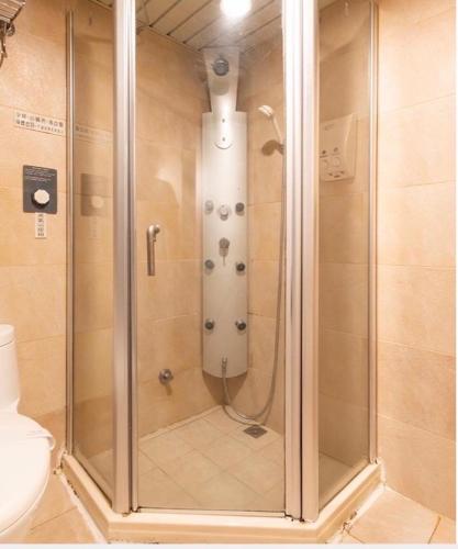 a shower with a glass door in a bathroom at Liya Boutique Hotel in Taipei