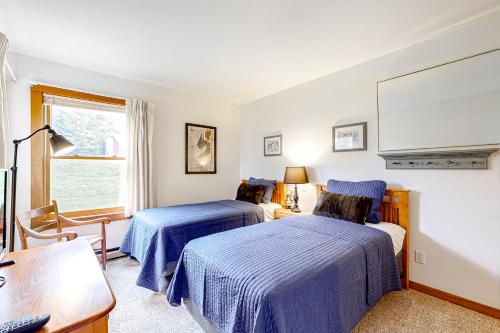 a bedroom with two beds and a window at Trail Creek 41 in Killington