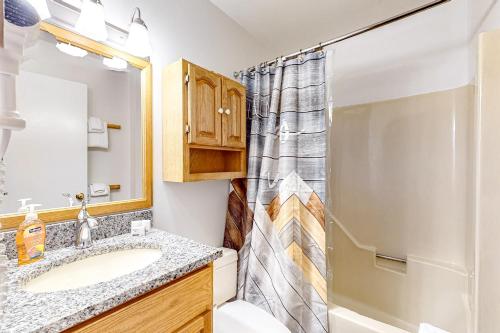 a bathroom with a sink and a shower at Trail Creek 41 in Killington