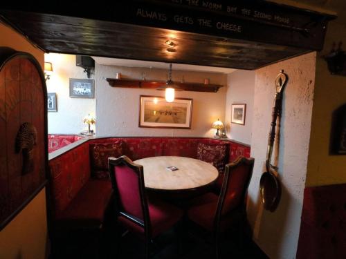 a dining room with a table and chairs at Ye Olde Cheshire Cheese Inn in Castleton