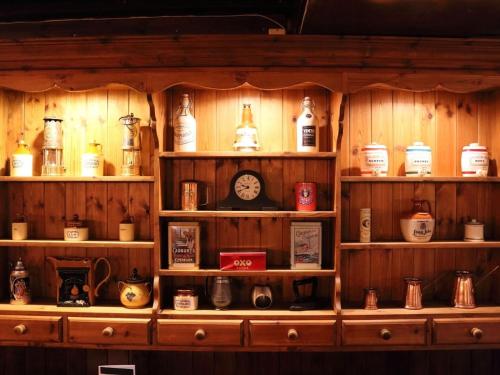 a shelf filled with lots of differentiatesiatesiatesiatesiatesiatesiatesktop at Ye Olde Cheshire Cheese Inn in Castleton
