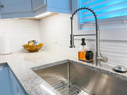 a kitchen counter with a sink and aaucet at Cozy New Build Entire Home - 5 Star Getaway in South Euclid