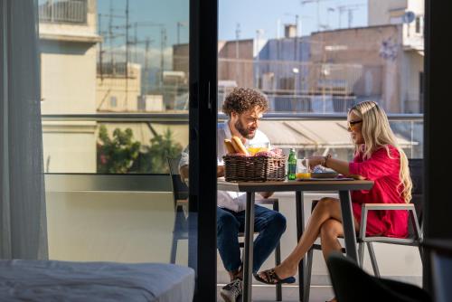 a man and a woman sitting at a table at Hestia - Averof 7 in Athens