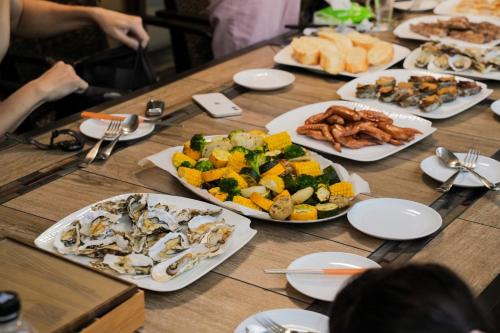 a wooden table with plates of food on it at Sakura VILLA B&B in Yuanshan