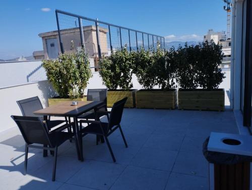 a table and chairs on top of a roof at Hestia - Averof 7 in Athens