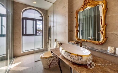 uma casa de banho com um lavatório e um espelho em Guava Hill Boutique Hotel em Da Lat