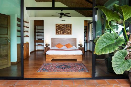 a bedroom with a bed in a room at Chalala villa with bio-pool & Sala! in Chiang Mai
