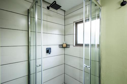 a shower with a glass door and a window at Self-Catering at Cozy Comfort in Durban