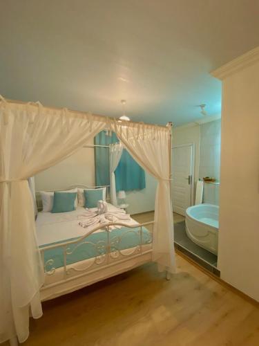 a bedroom with a bed and a tub in a room at Lemon-Ada Butik Otel in Kusadası