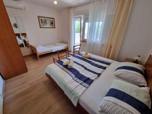 a bedroom with two beds and a window at Apartment in Crikvenica 5155 in Crikvenica