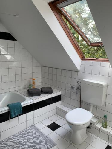 a bathroom with a toilet and a bath tub at Kleines Apartment in Mönchengladbach-Neuwerk in Mönchengladbach