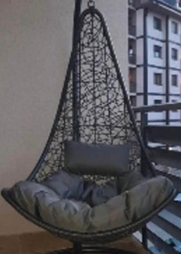 a hanging chair with a cushion in a room at Vila Pekovic Central-Apartman PAMA in Zlatibor