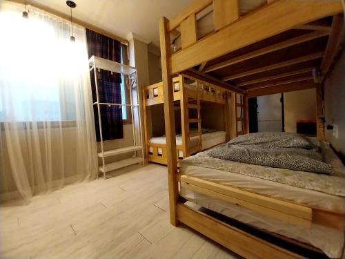 a bedroom with two bunk beds and a window at Pohang Youngildae Guesthouse in Pohang