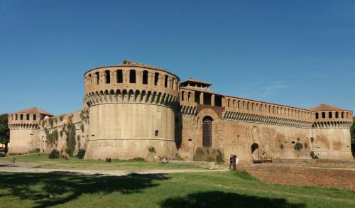 a large building with a tower on the side of it at Appartamento Imola con splendida vista sul Duomo in Imola