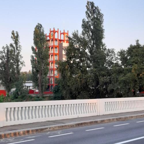 a white fence on the side of a road with a building at Appartamento Imola con splendida vista sul Duomo in Imola