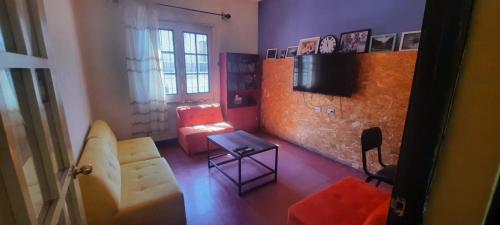a living room with a couch and a tv at Peter's Hostel in Arequipa
