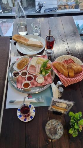 a wooden table with plates of food on it at XANTHI POLIS CITY CENTER with private parking in Xanthi