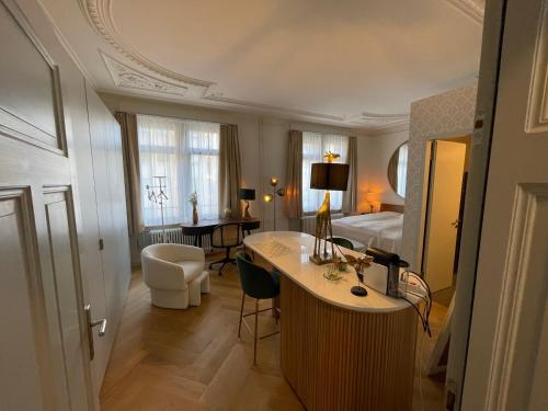 a hotel room with a bed and a desk at Exclusive one room apartment next to Zürich main station in Zurich