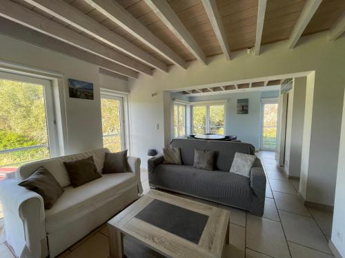 a living room with a couch and a table at North Sea Cottage Middelkerke in Middelkerke