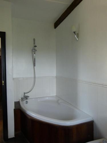 a bath tub in a bathroom with a shower at The Great Hall in Penrith