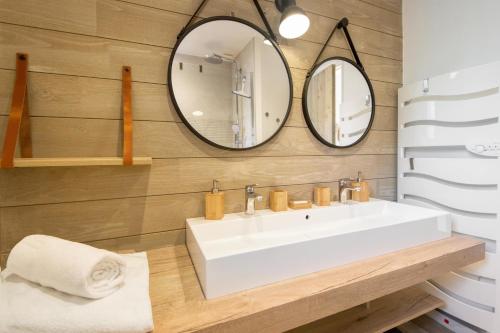 a bathroom with a white sink and two mirrors at DUNE, villa avec piscine et spa / Proche plage in La Couarde-sur-Mer