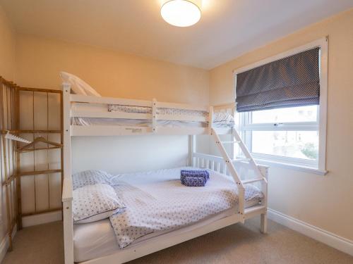 1 Schlafzimmer mit 2 Etagenbetten und einem Fenster in der Unterkunft Seaview at The Doocot in Elgin