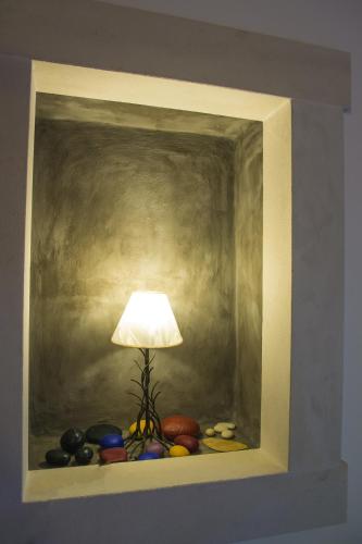a painting of a lamp on a shelf with rocks at Su La Strata Villa by CorfuEscapes in Gaios