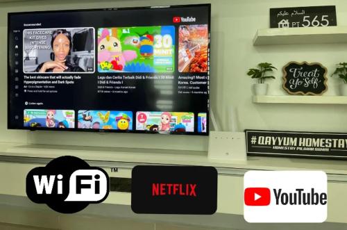 a flat screen tv on a shelf in a store at Qayyum Homestay Pauh Lima,Bachok,Kelantan in Bachok