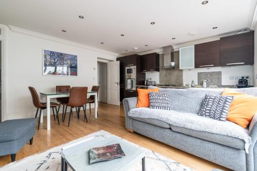 a living room with a couch and a table at Gorgeous Kentish Town Flat in London