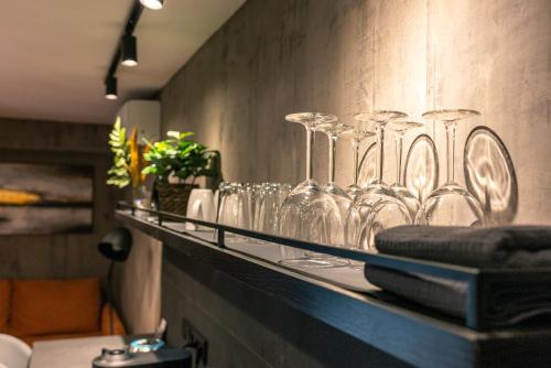 a shelf with wine glasses on a wall at Apartments DREAM in Málaga