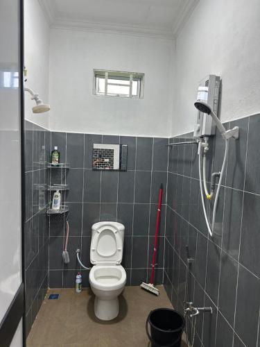 a bathroom with a toilet and a shower at Dhia Homestay2 in Machang