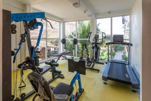 a gym with several exercise bikes in a room at Canary Nungwi Hotel & SPA in Nungwi
