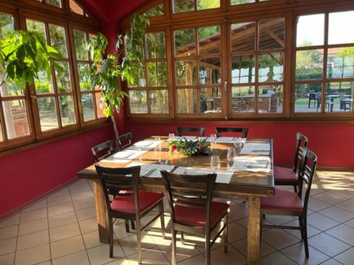 a dining room with a wooden table and chairs at Hotel Erbaluce in Caluso