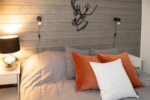 a bedroom with a bed with a antler on the wall at Levillenet Suites in Levi