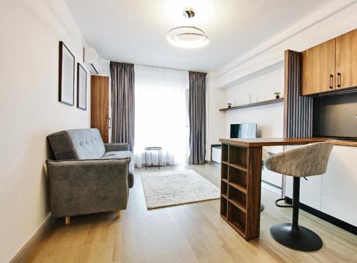 a living room with a chair and a desk at Himson-Brown Apartment in Iaşi