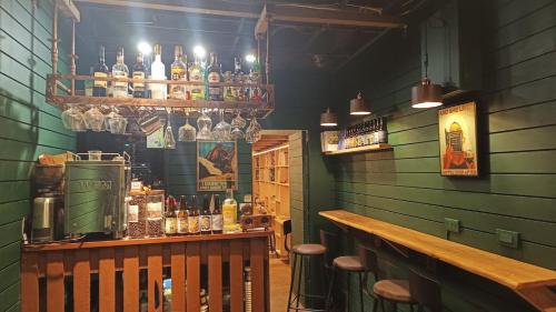 a bar with a counter and bottles of alcohol at Hsinchu Book&Bed in Hsinchu City